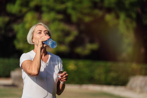 istock Mature woman drinking water 1310147366