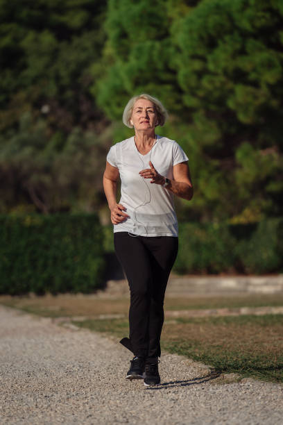 istock Senior woman jogging at sunrise 1310147452