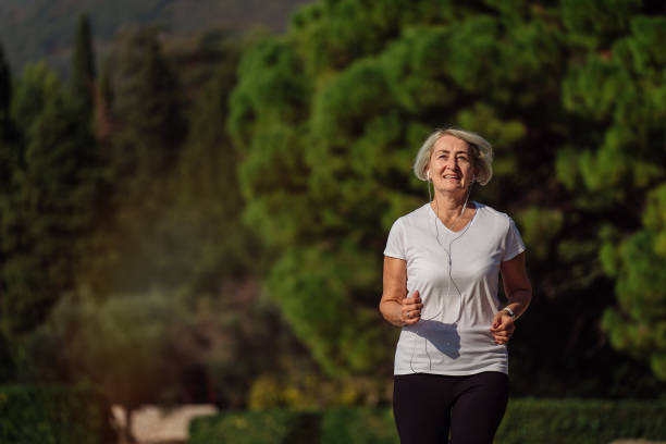 istock Senior woman jogging at sunrise 1310147467