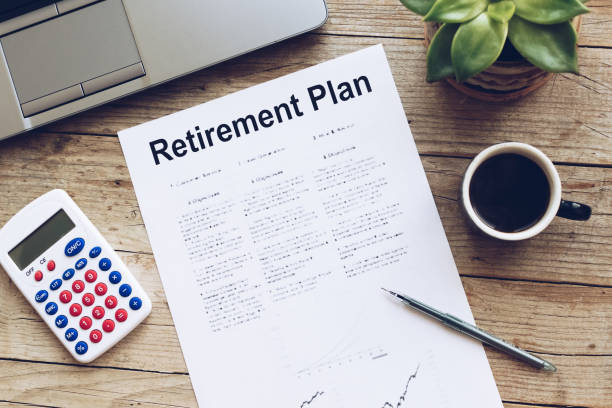 istock Retirement Plan. Calculator, pen and notebook on wooden table 1310147513