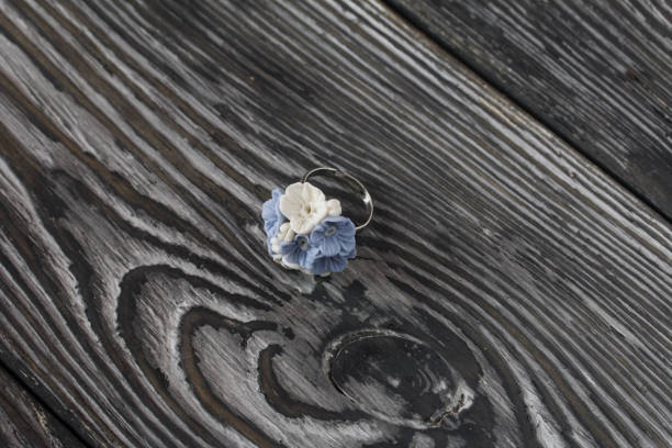 istock Handmade jewelry. Polymer clay ring. Lies on pine boards. 1310147668