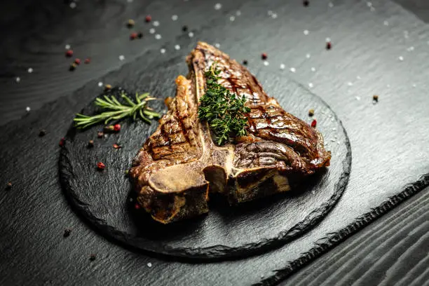 Photo of t-bone steak, porterhouse steak, bistecca alla fiorentina. beef steak Medium rare. American cuisine. banner, catering menu recipe place for text, top view