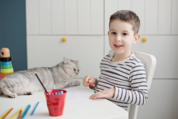 istock Child drawing with cat at home 1310153032