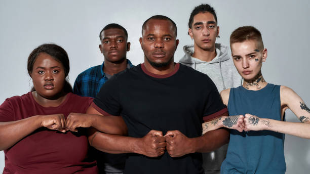 istock Young multiracial crowd holding hands in locked fists 1310156002