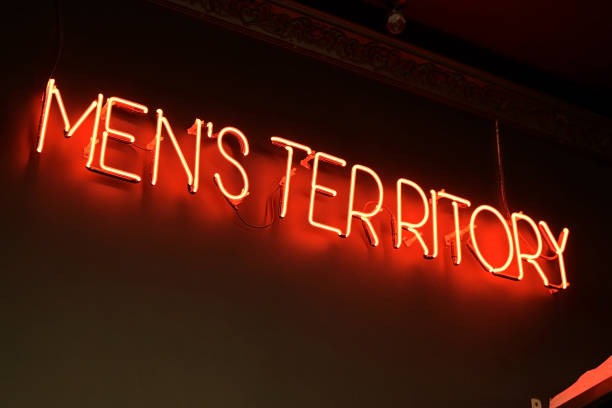 istock A red neon sign with the words mens territory hangs on the wall inside a salon 1310158260