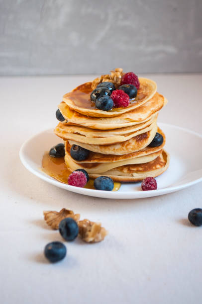 istock Delicious pancakes with blueberries and raspberries on a white plate. 1310158710