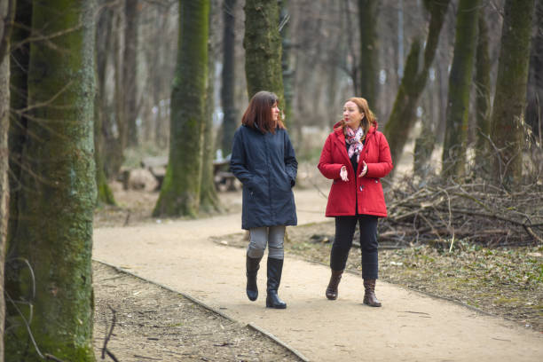 istock Two female friends walking through the forest 1310159560