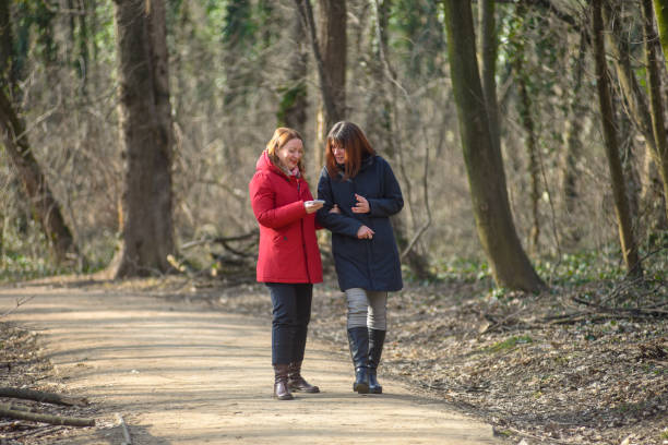 istock Two female friends walking through the forest 1310159594