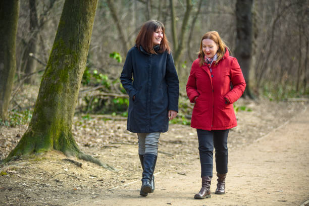 istock Two female friends walking through the forest 1310159621