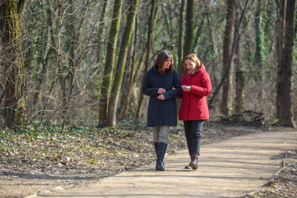 istock Two female friends walking through the forest 1310159656