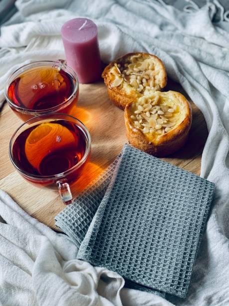 pies with nuts on a round board and two cups of tea