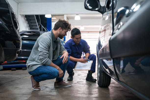 istock Car mechanic checking wheel in garage 1310162710