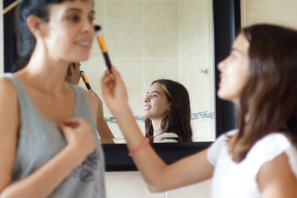 istock mother and daughter makeup in the bathroom 1310162824