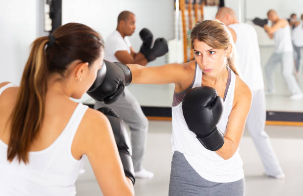 istock Concentrated woman practicing boxing punches in sparring 1310163463