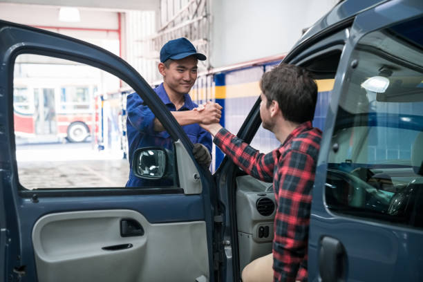 istock Customer shaking hand with car mechanic 1310163696