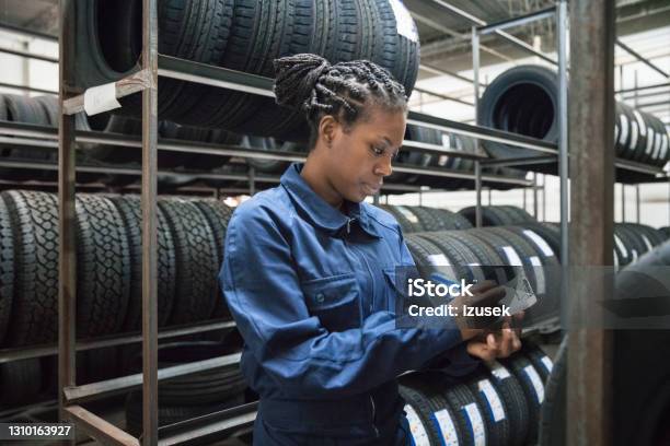 Female Car Mechanic At Work Stock Photo - Download Image Now - Tire - Vehicle Part, Sale, Car