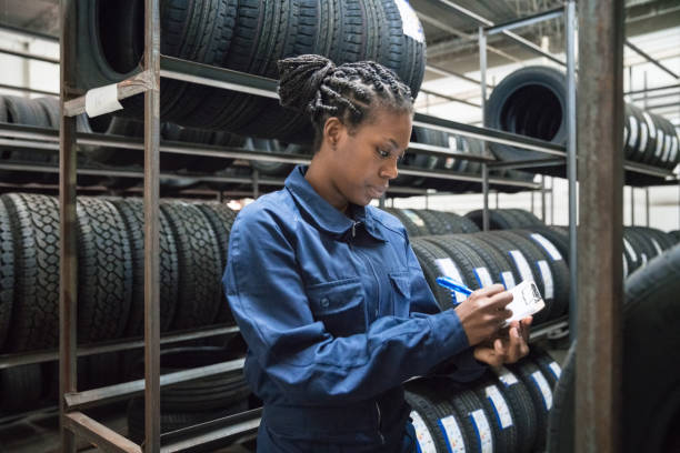 female car mechanic at work - trainee working car mechanic imagens e fotografias de stock