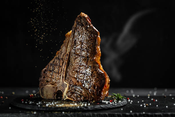 Aged Barbecue Porterhouse Steak. Beef T-Bone juicy steak rare beef with spices. American cuisine. The concept cooking meat. Medium rare Grilled T-Bone Steak, Barbecue aged wagyu porterhouse stock photo