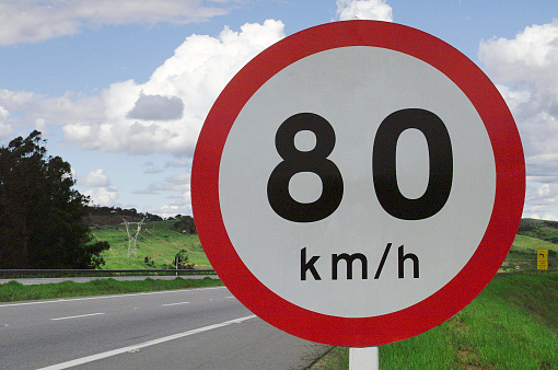 There is a temporary road sign on the motorway - the narrowing of the road and the speed limit of 90 km per hour.