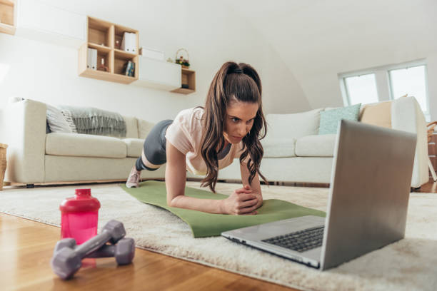 istock Woman training at home in a plank position 1310167566
