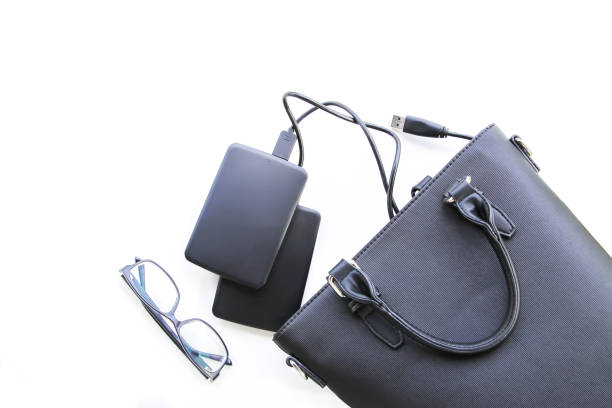 istock Composition with black bag, hard disks and glasses 1310168299