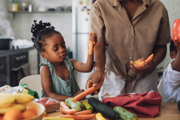 istock Mother Teaching Her Kids about Vegetables 1310168641