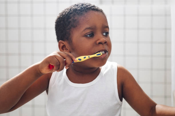 istock Young Boy Washing his Teeth in a Bathroom 1310168723