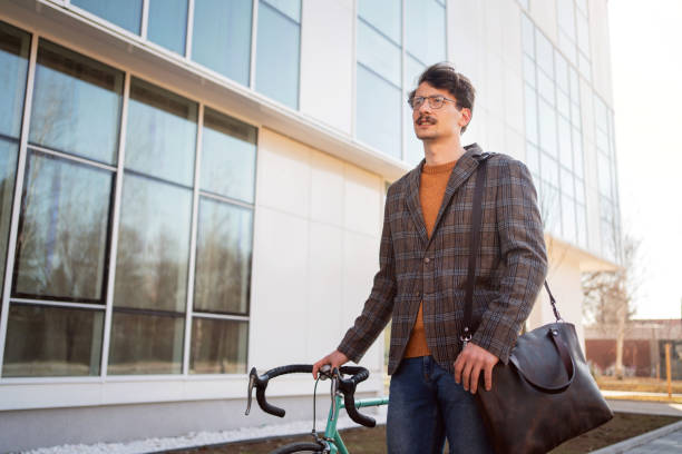 istock Young stylish businessman going to work by bike 1310168796
