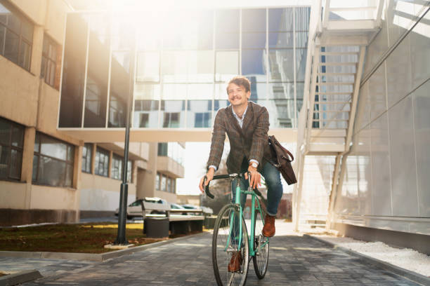 istock Low-angle view of a young man cycling on his way to work 1310168859