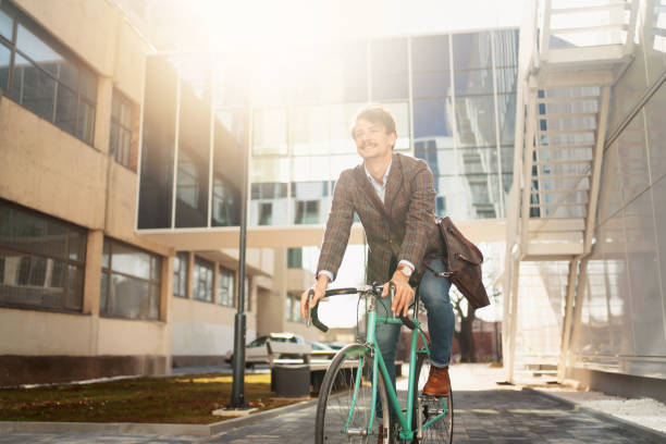 istock Smiling young man cycling on his way to work 1310168866