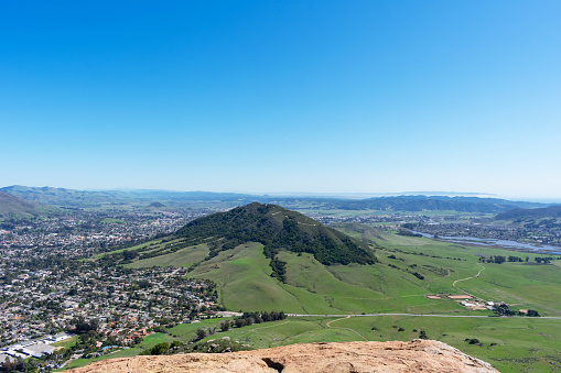 Aerial scenic view from the top of Bishop Peak toward Cerro San Luis Obispo mountain on sunny spring day