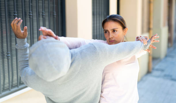istock Hispanic girl applying self defence moves to protect from robbery 1310175445