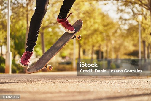 istock Unrecognizable man jumping with skateboard. Skating concept. 1310175646