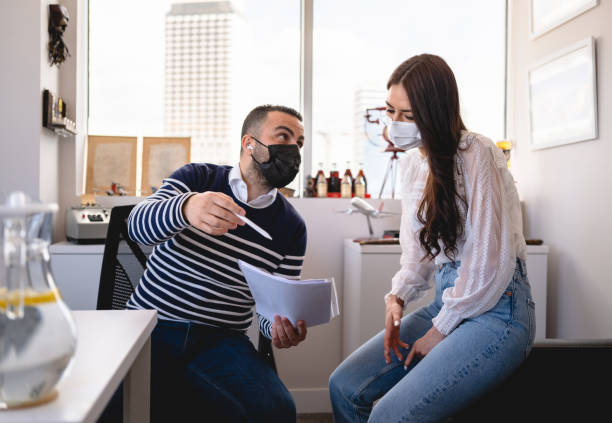 istock Business People With Protective Face Mask Discussing 1310176523