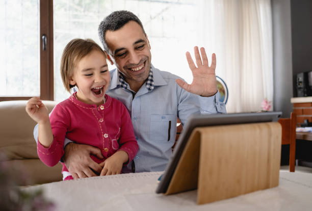 istock Father And Little Daughter On A Video Call Using Digital Tablet 1310176632