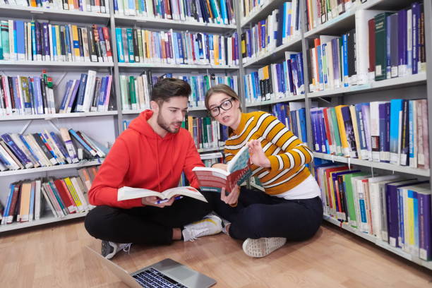 istock the students uses a notebook, laptop and a school library 1310182651