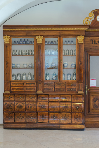 Bratislava. Slovakia. Summer 2019. Shelves with cans in an old pharmacy. Cabinets with glass shelves. Banks with medicines.
