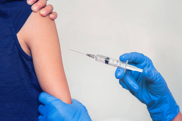 istock doctor makes the patient an injection on white background close-up 1310183518