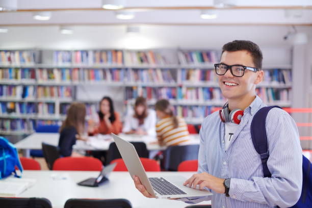 istock the student uses a notebook, latop and a school library 1310189333