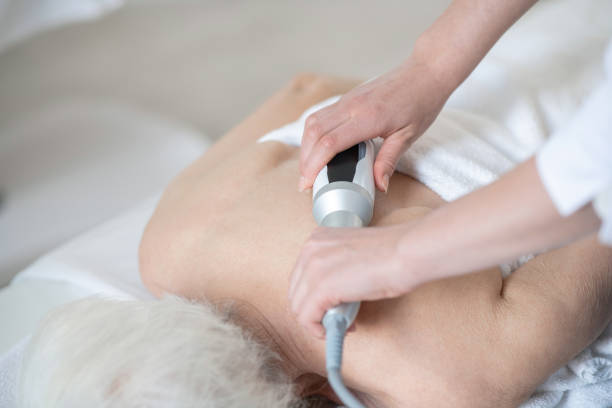 istock Massage therapist doing back massage procedures to a gray-haired woman 1310191775