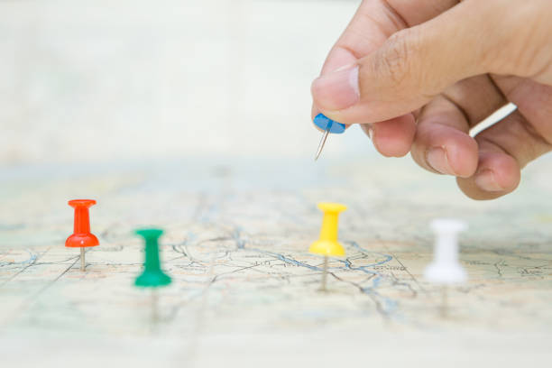 istock Selective focus of hand holding a pin on map background 1310193950