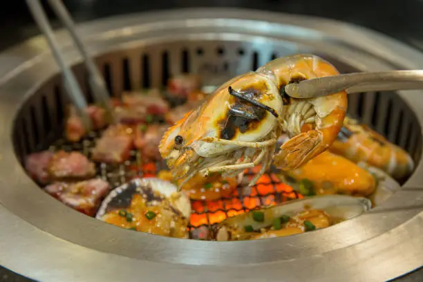 Photo of Pick Grilled shrimp on a charcoal stove
