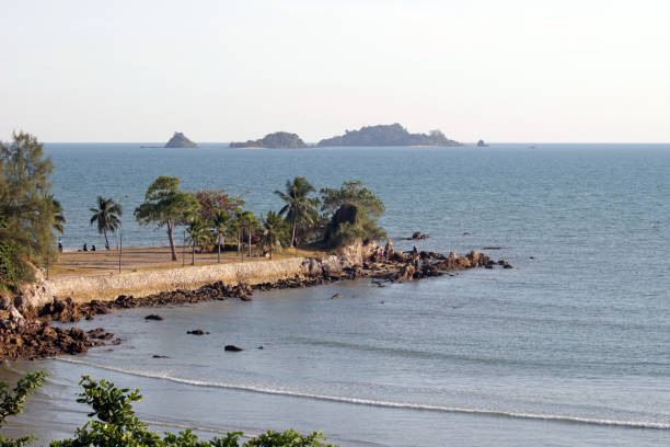 istock Peaceful beach scene with a rocky outcrop going out into the ocean 1310196725
