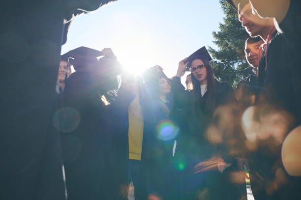istock Group of diverse international graduating students celebrating 1310201639