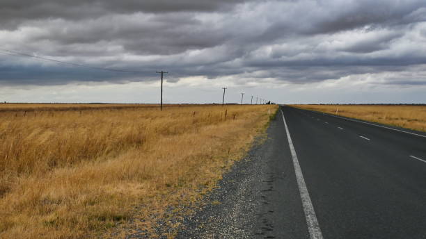 istock Road to Urana Under Cloudy Sky 1310202390