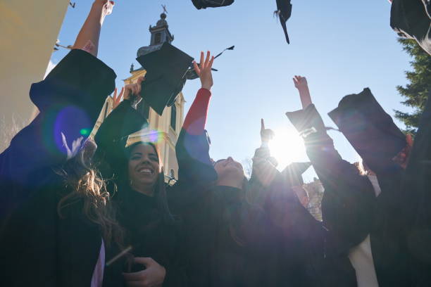 istock Group of diverse international graduating students celebrating 1310202444