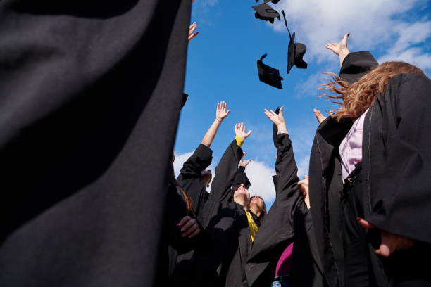 istock Group of diverse international graduating students celebrating 1310202722