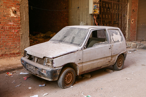 Giza, Egypt - January 26, 2021: Abandoned Russian minicar Lada Oka in the city street.