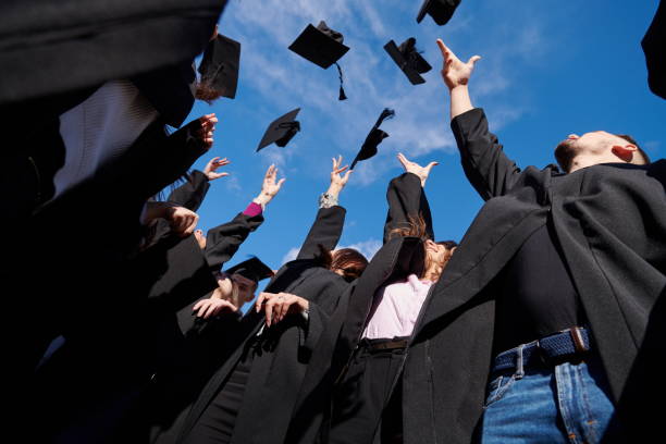 istock Group of diverse international graduating students celebrating 1310206825