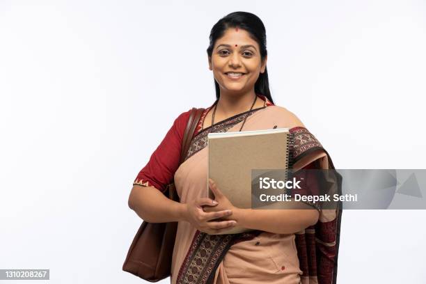 Portrait Of Indian Woman As A Teacher In Sari Standing Isolated Over White Background Stock Photo Stock Photo - Download Image Now